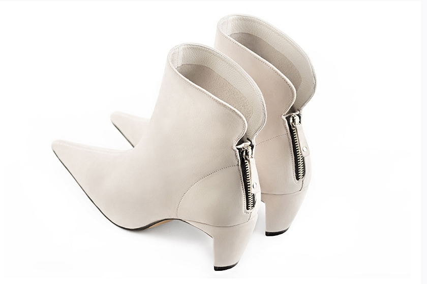 Off white women's ankle boots with a zip at the back. Pointed toe. Low comma heels. Rear view - Florence KOOIJMAN